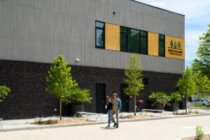Trees Atlanta headquarter building couple walks toward entrance